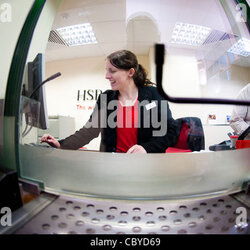 Woman Bank Teller At Stock Photo Working Behind The Counter Branch Of